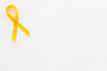 Disease control concept. Yellow ribbon on white background top view space for text