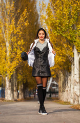 Portrait of a young beautiful woman in a white down jacket