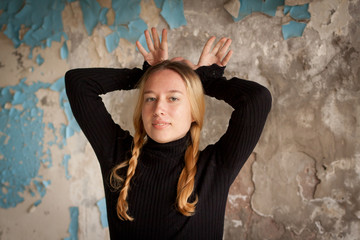 girl playing, depicting a deer on a background of an old wall