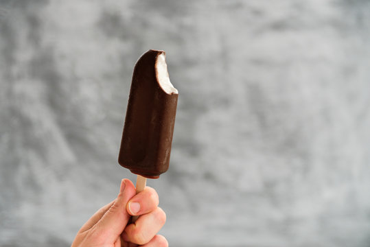 Woman holding Eskimo pie in hand