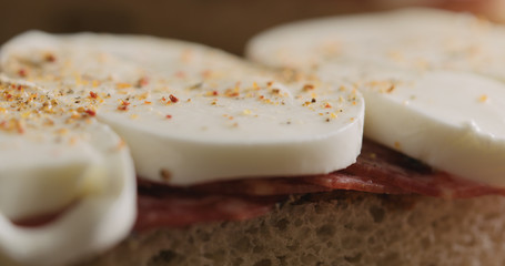 Extreme closeup put top on slami mozzarella sandwich