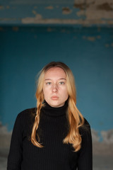 sad girl on a background of an old wall