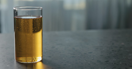 pear cider into glass on terrazzo countertop with copy space