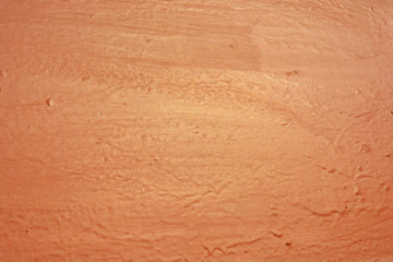 Old metal building sheet covered with brown paint with a golden tint in bright sunlight. Interesting structure and texture with gilding.