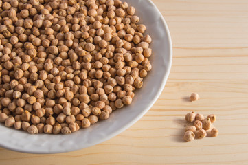 still life plate with chickpeas, isolated on wooden background