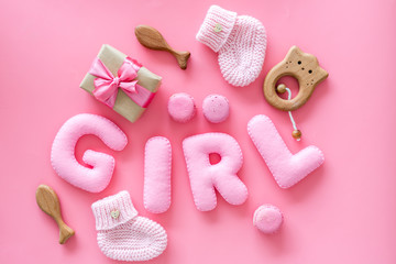 Girls's birthday concept. Pink baby set with gift box on pink backgound top view