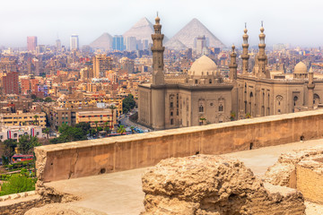 Cairo view, the Mosque-Madrassa of Sultan Hassan and the Pyramids, Egypt © AlexAnton