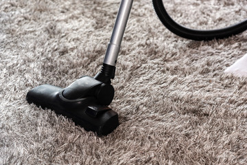 Home cleaning concept - cleaning the room with carpet sweeper in close-up