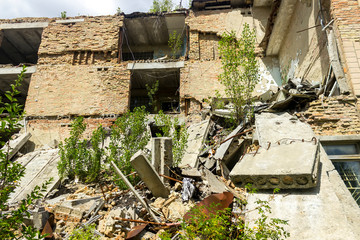 The ruins of residential buildings, the dark trash of collapsed houses as a result of the economic crisis and earthquake. The interior of the old buildings is destroyed.