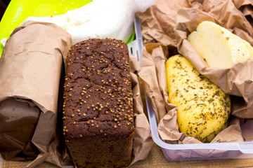 mix of various varieties of hard cheese on a wooden board. View from above.