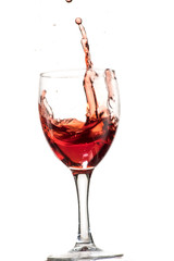 a splash of red wine in a glass on a white background