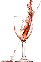 a splash of red wine in a glass on a white background