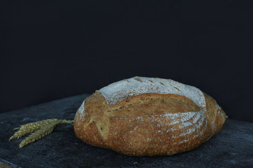 Fresh homemade bread. round bread on a dark background. Mother dough bread. Homemade bread sourdough, rustic baked bread