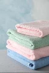 Stack of clean towels on ironing board, copy space