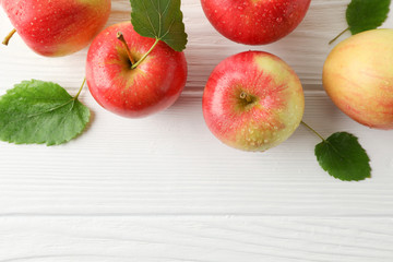 Composition with apples on white wooden background, top view