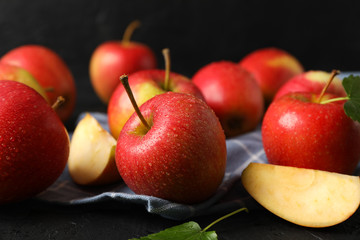 Apples and kitchen towel on black background, close up