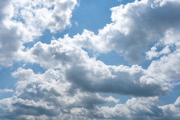 Fototapeta na wymiar Glowing clouds on a background of blue sky. White fluffy luminous cloud