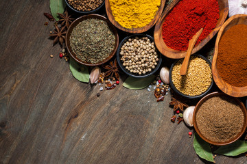 assortment of various spices on a wooden table