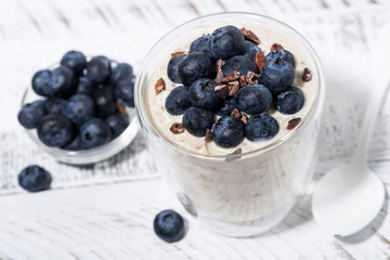 bircher muesli with fresh blueberries, top view closeup