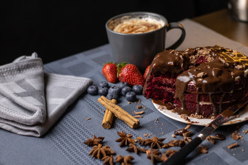 chocolate cake with berries and cup of coffee