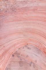 Zion National Park in Utah on Gifford Canyon trail with vertical closeup red pink sandstone layers wave formation on rock wall cliff abstract design
