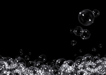 Clear soap bubbles floating on black background with copy space