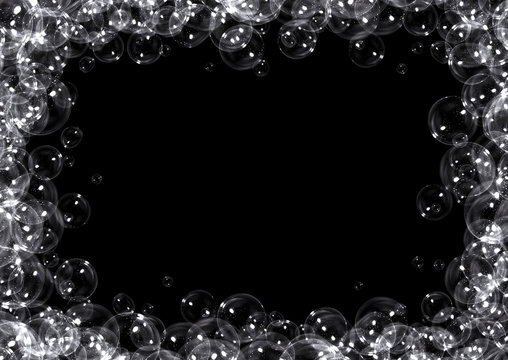 Clear soap bubbles frame on black background with copy space