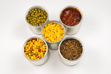 Canned food on white background. Green pea, beans, corn, lentils.