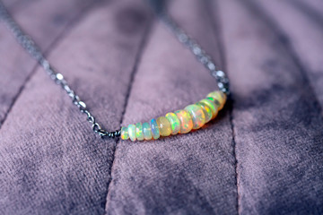 Natural opal gemstone necklace on pink velvet