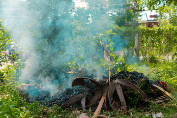 Burning garbage. grass and leaves burns in the garden. Fire and Smoke from during Burning of garden waste. Garbage in fire.