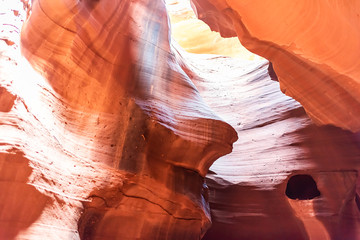 Antelope slot canyon with abstract formations of red orange rock layers sandstone and imagery of honey dripping from hole in Page, Arizona