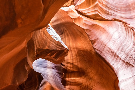 Low angle view of upper Antelope slot canyon with wave shape abstract formations of red orange rock layers sandstone in Page, Arizona