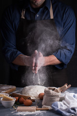 Baker prepares the dough on table. Homemade pastry.