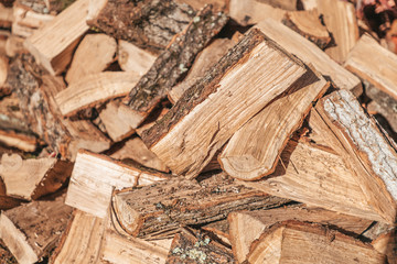 Preparation for the heating season. Chopped wood close-up. Brown colors. Background, texture. Horisontal