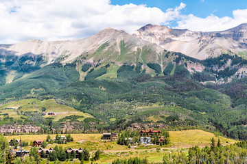 Fototapeta na wymiar Aerial high angle view of rocky San Juan mountains from Telluride, Colorado with beautiful valley and Mountain Village houses on summer day