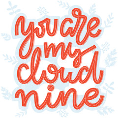 Coral pink lettering saying You are my cloud nine. Handwritten romantic lettering in coral and white on blue and white cloud and twigs and leaves background. Template for greeting and postcards
