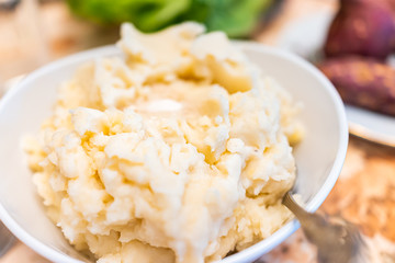 Closeup of table setting for Thanksgiving dinner and vegetables macro texture of mashed potatoes in bowl with spoon