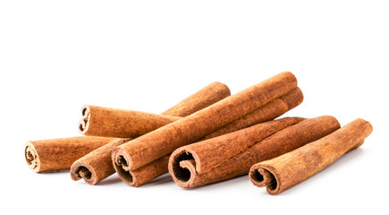 Pile of cinnamon sticks close up on a white. Isolated.