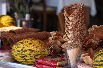 Close up of ice cream cones and next to melon and water bottle.Close up of chocolate ice cream cones and next to it is melon and water bottle.