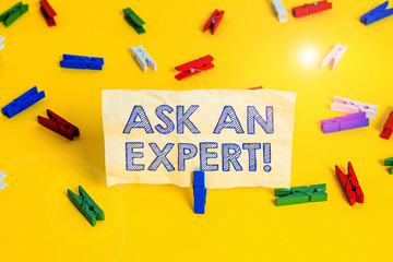 Writing note showing Ask An Expert. Business concept for confirmation that have read understand and agree with guidelines Colored clothespin papers empty reminder yellow floor background office