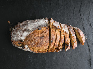  bread with raisins on black background