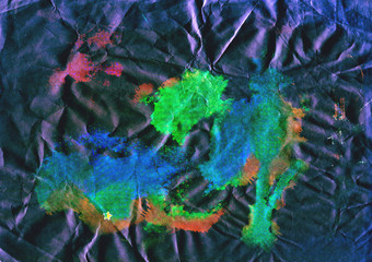 colored textured watercolor spots on a crumpled background