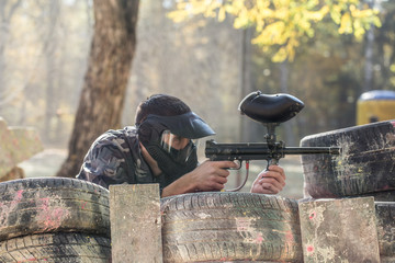 A man with a gun playing paintball.