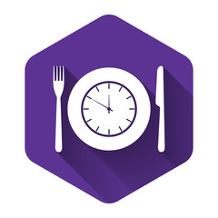 White Plate with clock, fork and knife icon isolated with long shadow. Lunch time. Eating, nutrition regime, meal time and diet concept. Purple hexagon button. Vector Illustration