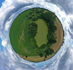 360 degree spherical drone aerial panoramic view on agricultural landscape with swamp pond, trees, fields and meadow.