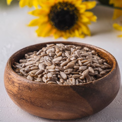 Wooden bowl of sunflower seeds. Closeup