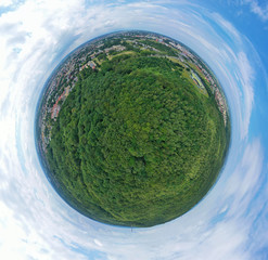 Aerial drone 360 degree panoramic view on green lungs forest surrounding european city during...
