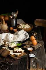 salad with hard boiled eggs, potato, green onion, mayonnaise in wooden bowl 