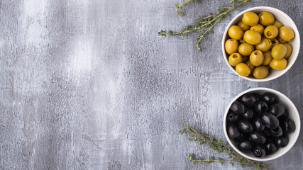 Black and Green olives  in a bowl with copy space. Top view