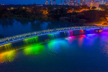 Aerial view of Starlight Bridge or Anh Sao Bridge which is a pedestrian bridge with colored lights and waterfall in District 7 of Ho Chi Minh City also known as Saigon, Vietnam. 